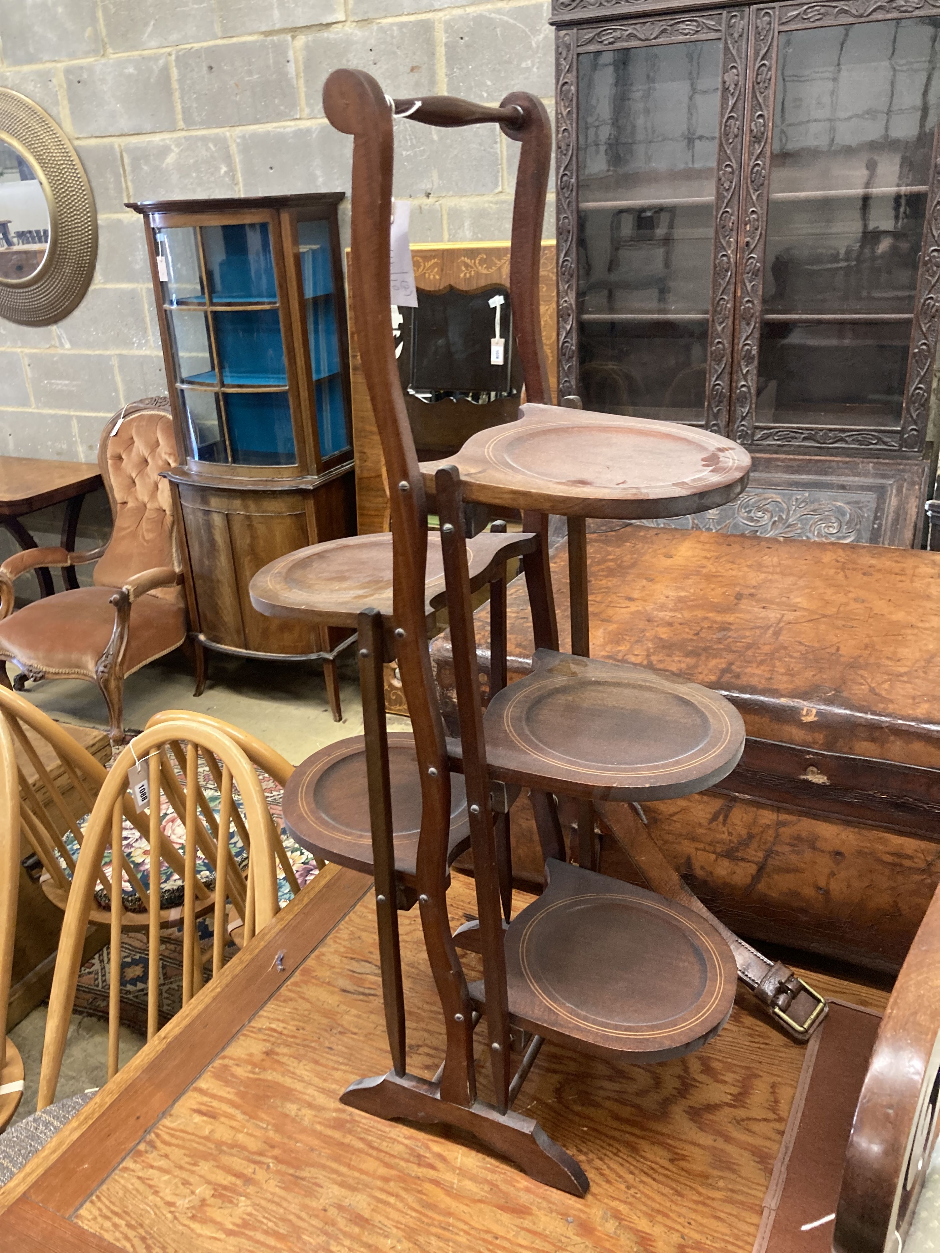 An Edwardian mahogany folding cake stand together with a mahogany toilet mirror